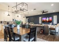 Open-concept living room featuring a large kitchen island, modern lighting, and a stylish blue accent wall at 6858 E Orion Dr, Scottsdale, AZ 85257