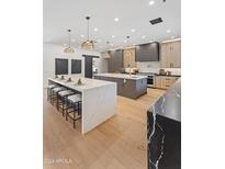 Open-concept kitchen with double islands, a breakfast bar, stainless steel appliances, and hardwood floors at 7014 E Palo Verde Ln, Paradise Valley, AZ 85253