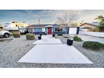 Charming blue single-story home with desert landscaping, gravel, and a welcoming red front door at 1207 E Alice Ave, Phoenix, AZ 85020