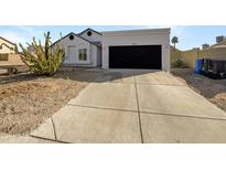 Charming single-story home featuring a desert landscape and attached two-car garage at 1517 E Piute Ave, Phoenix, AZ 85024