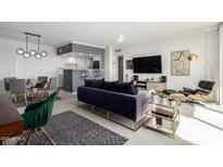 Bright open floor plan living room with views to the dining area at 207 W Clarendon Ave # 5H, Phoenix, AZ 85013