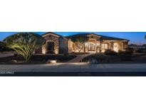 Inviting front exterior showcasing stone accents, lush landscaping, and a charming, lit pathway to the front door at 2330 N Channing --, Mesa, AZ 85207