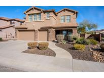 Two-story home featuring a two-car garage, neutral stucco, stone accents and landscaped walkway and garden at 5110 W Sweet Iron Pass, Phoenix, AZ 85083