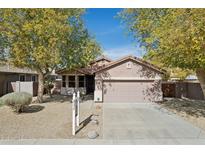 Charming single-story home featuring mature trees, a two-car garage, and well-maintained landscaping at 7204 W Judy Lynn Ln, Peoria, AZ 85382