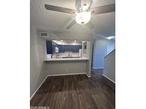 Open kitchen view with breakfast bar, modern cabinetry and stainless steel appliances at 2121 S Pennington St # 2, Mesa, AZ 85202