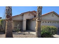 Charming single-story home with desert landscaping, a tile roof, and a two-car garage at 23167 W Lasso Ln, Buckeye, AZ 85326