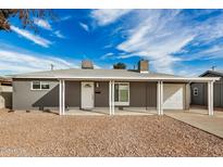 Charming single-story home with grey exterior, covered porch, and low-maintenance desert landscaping at 2944 W Royal Palm Rd, Phoenix, AZ 85051