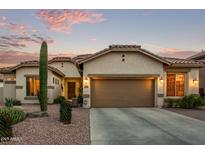 Charming home showcasing desert landscaping and a neutral-toned exterior with a spacious two-car garage at 3401 E Isaiah Ave, Gilbert, AZ 85298