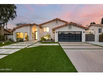 Stunning home featuring a landscaped yard, modern garage door, and beautiful architecture at 4748 E Redfield Rd, Phoenix, AZ 85032