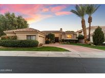 Inviting single-story home with lush landscaping, a tile roof, and a circular driveway at 7327 E Via Estrella Ave, Scottsdale, AZ 85258