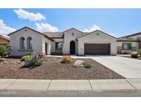 Charming single-story home featuring a desert landscape and a two-car garage with beautiful blue sky at 16949 W La Reata Ave, Goodyear, AZ 85395