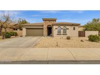 Inviting home with a two-car garage, stone accents, desert landscaping, and a covered front entry at 2514 E Espada Trl, Casa Grande, AZ 85194