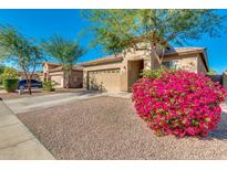 Charming single-Gathering home with a well-manicured lawn, mature trees, and a two-car garage at 7318 W Sophie Ln, Laveen, AZ 85339