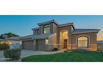 Beautiful two-story home featuring a well-manicured lawn and a three-car garage at 7415 W Via De Luna Dr, Glendale, AZ 85310