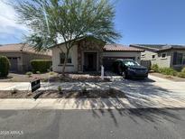 Charming single-story home featuring stone accents, desert landscaping, and an inviting entrance at 20407 W Calle Encorvada --, Buckeye, AZ 85396