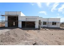 Exterior shot of home under construction with scaffolding and blue skies, exhibiting modern design and potential at 29022 N 166Th Ave, Surprise, AZ 85387