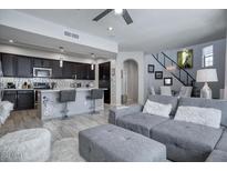 Open concept living room and kitchen with stainless steel appliances and modern design at 3935 E Rough Rider Rd # 1267, Phoenix, AZ 85050
