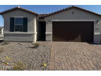 Charming single-story home featuring a paver driveway, a stucco exterior, and a well-manicured yard at 39965 W Elm Dr, Maricopa, AZ 85138