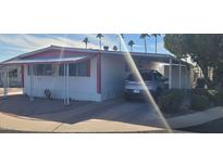 Well-maintained manufactured home with covered parking and desert landscaping at 44 S Hawes Rd # C13, Mesa, AZ 85208