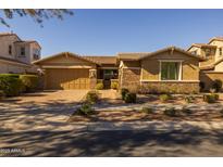 Charming single-story home with a well-maintained front yard and a two-car garage at 5054 S Advant Ter, Mesa, AZ 85212