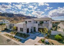 Two-story home boasts desert landscaping, three-car garage, concrete accents and mountain views at 921 E Buist Ave, Phoenix, AZ 85042