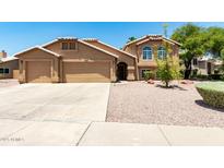 Charming two-story home featuring a three-car garage and well-maintained desert landscaping at 926 W Grand Caymen Dr, Gilbert, AZ 85233