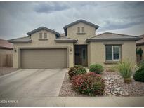 Charming single-story home features a low maintenance desert landscape and two-car garage at 10909 E Sentiero Ave, Mesa, AZ 85212