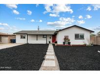 Charming single-story home featuring a red front door, manicured front yard, and sidewalk at 1504 W 6Th St, Mesa, AZ 85201