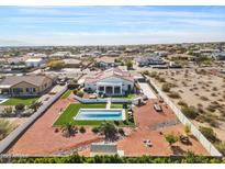 Expansive aerial view of property featuring a pool, covered patio, and landscaped yard with desert foliage at 19612 W Georgia Ave, Litchfield Park, AZ 85340