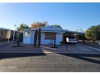 Charming single-story home with a covered parking and desert landscaping at 3160 E Main St # 72, Mesa, AZ 85213