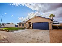 Charming single-story home features a blue garage door, manicured lawn, and ample driveway parking at 502 N 110Th St, Mesa, AZ 85207
