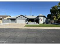 Charming home featuring a well-manicured lawn and a welcoming front porch at 6434 W Shaw Butte Dr, Glendale, AZ 85304
