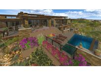 Expansive backyard featuring a swimming pool, patio, and beautiful desert landscaping at 10020 E Relic Rock Rd # 18, Scottsdale, AZ 85262