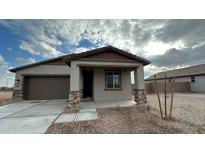 Charming single-story home featuring a covered front porch with stone accents and a two car garage at 15773 W Hackamore Dr, Surprise, AZ 85387