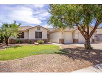 Charming single-story home featuring a well-manicured lawn and desert landscaping at 20329 E Bronco Dr, Queen Creek, AZ 85142