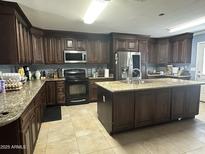 Spacious kitchen with island, stainless steel appliances, and granite countertops offering ample space at 216 N 88Th St, Mesa, AZ 85207