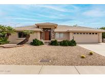 Charming single-story home with a desert-landscaped yard, stone accents, and a two-car garage at 2503 S Tambor --, Mesa, AZ 85209