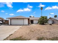 Charming single-story home with a two-car garage and a low maintenance desert-style yard at 3429 W Aire Libre Ave, Phoenix, AZ 85053