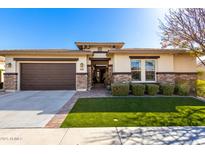 Beautiful single-story home featuring stone accents, a two-car garage, and manicured lawn in a desirable neighborhood at 3749 E Riopelle Ave, Gilbert, AZ 85298