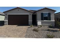 Charming single-Gathering home featuring a manicured front yard and a two-car garage at 39993 W Anne Ln, Maricopa, AZ 85138