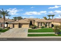 Charming home featuring a three-car garage, manicured lawn, and desert landscaping at 4862 S Jojoba Way, Chandler, AZ 85248