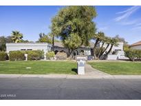 Charming single-story home with lush landscaping, mature trees and a well-manicured front yard at 5478 E Oakhurst Way, Scottsdale, AZ 85254