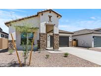 Charming stucco home featuring stone accents and a well-manicured desert landscape at 550 E Aurora Dr, San Tan Valley, AZ 85140