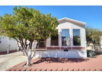 Charming mobile home with well-maintained front yard and mature tree providing ample shade at 7750 E Broadway Rd # 212, Mesa, AZ 85208