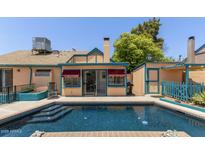 Inviting backyard pool with patio area, attached shed, and charming exterior details at 9919 N 67Th Dr, Peoria, AZ 85345