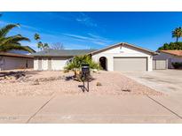 Charming single-story home with desert landscaping, mailbox, and attached two-car garage at 2024 E Gemini Dr, Tempe, AZ 85283