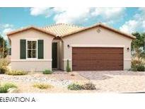 Charming single-story home showcasing a spacious two-car garage and lovely desert landscaping at 21505 N Rummler Ln, Maricopa, AZ 85138