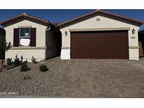 Charming single-story home featuring a brick driveway and neutral color palette at 21505 N Rummler Ln, Maricopa, AZ 85138