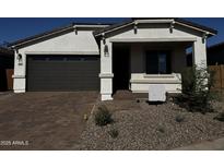 Charming single-story home featuring a two-car garage and beautifully landscaped front yard at 21525 N Rummler Ln, Maricopa, AZ 85138