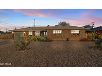 Charming single story brick home with beautiful landscaping and curb appeal, featuring a well maintained front yard and cozy exterior at 2232 W Verde Ln, Phoenix, AZ 85015